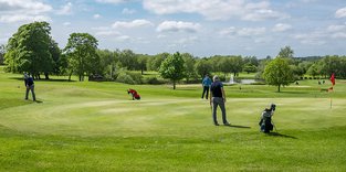 Golfers on putting green Ben Allen Golf & Leisure